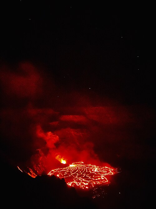 Bright red lava flows from Kīlauea during a night eruption in Hawaii.