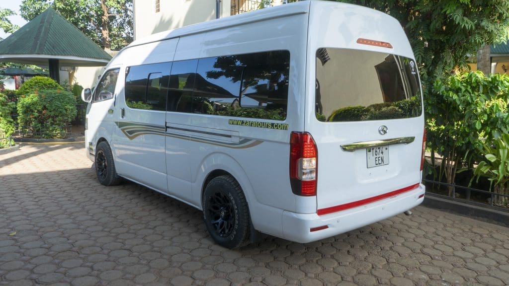 Zara Tanzania Adventures airport transfer van parked at the hotel, ready to transport guests comfortably.