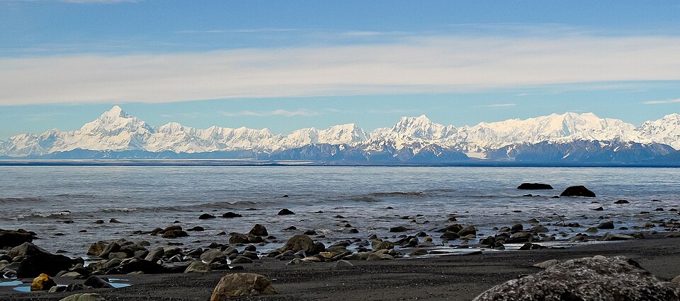 Snow-covered peaks of the Saint Elias Mountains viewed across a bay