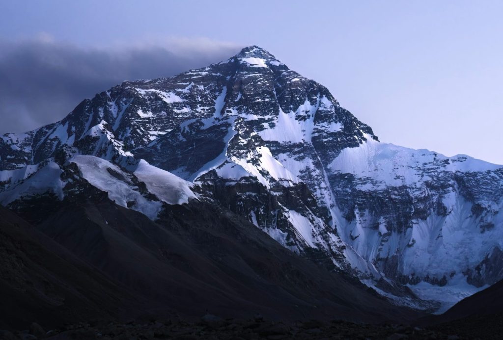Snow-covered Mount Everest peak under a clear sky