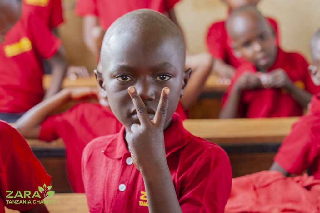 A young child at the Moshi Kids Centre supported by Zara Charity, symbolizing hope and education for underprivileged children in Tanzania.
